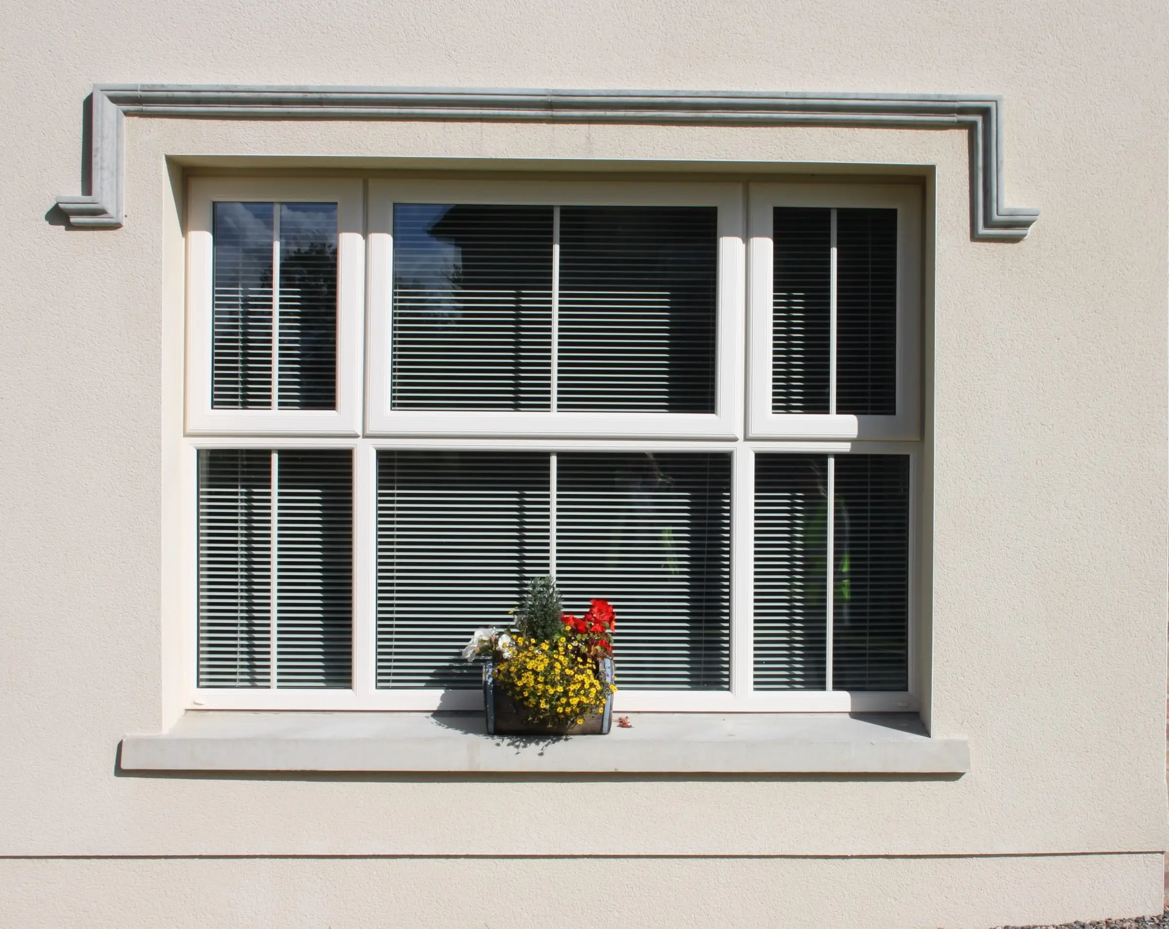 White uPVC casement window on a rendered house